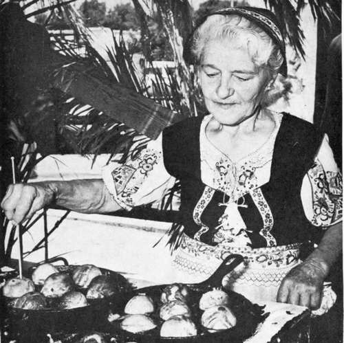 Cooking AEbleskiver in the street of Solvang on Danish Days.