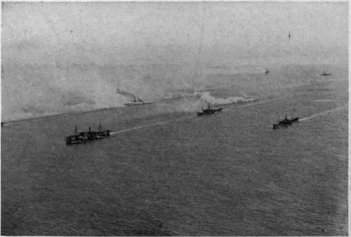 A threatened submarine attack. Throwing out a smoke screen to protect a convoy. British official photograph.