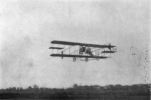Glenn H. Curtiss in one of his flying machines, equipped with balancing planes between the main planes.