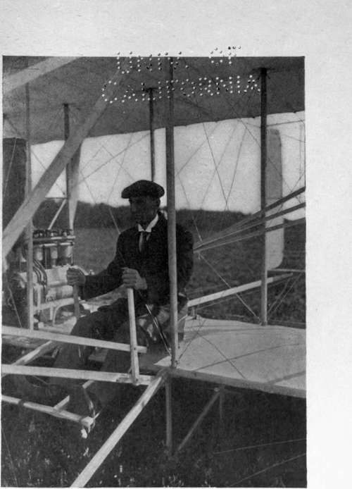 Mr. Wilbur Wright in the old type Wright biplane.