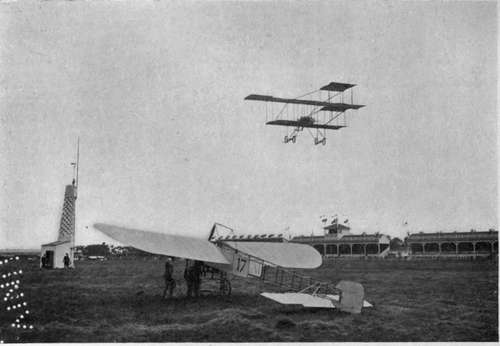 The machine in the air is a Farman biplane of the latest type.
